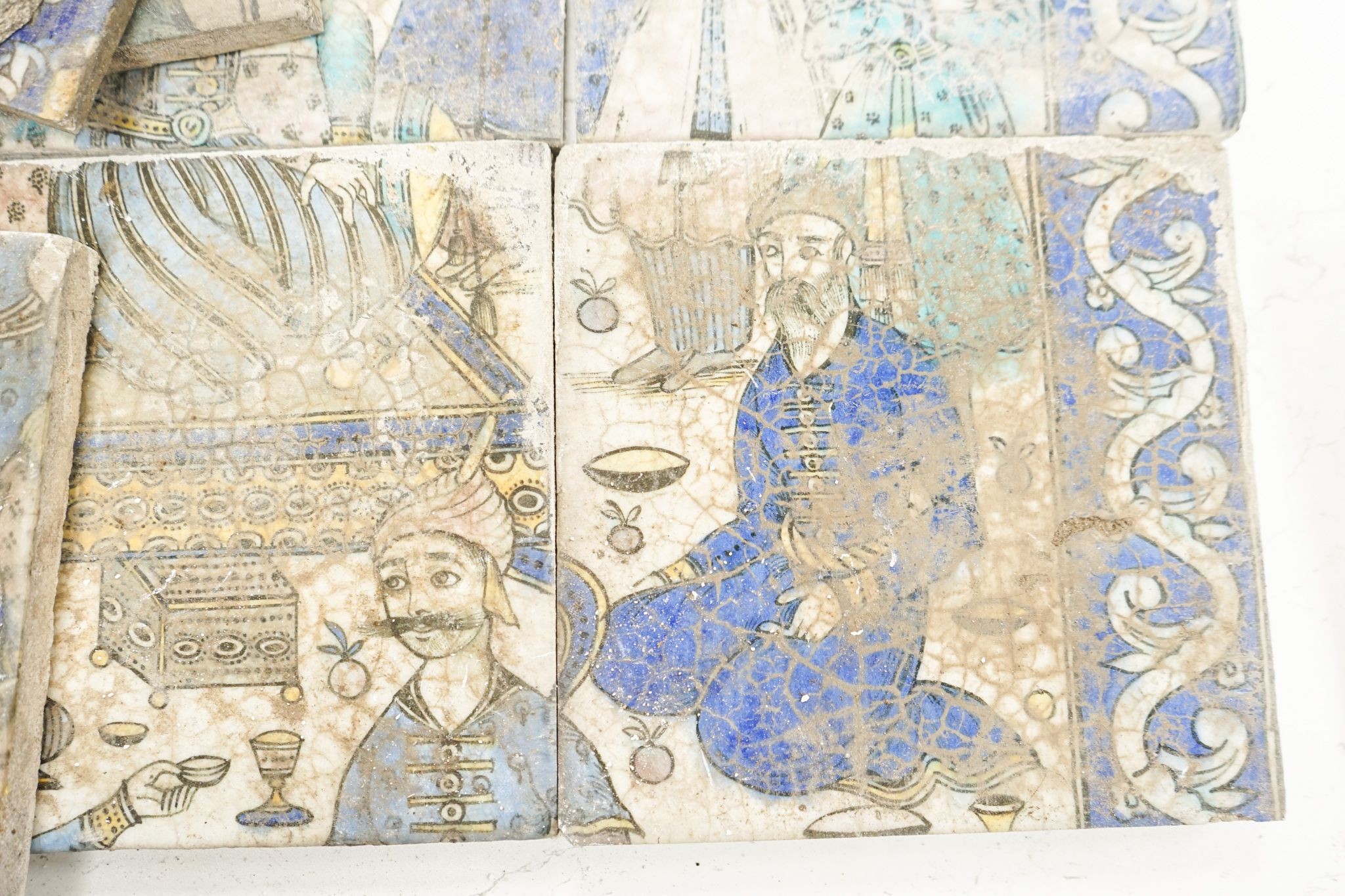 A Persian fritware tile panel, late 19th/early 20th century, incomplete, 55cm wide and another tile fragment